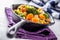 Vegan pan. Vegetarian food - broccoli carrot mushrooms salt pepper on butter