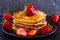 Vegan pancakes served with berries and maple syrup