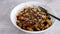 Vegan pesto fusilli pasta with black beans and mediterranean veggies topped ith mixed seeds, healthy plant-based recipes