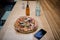 Vegan pizza on a table alongside a bottle of dressing and a smartphone