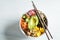 Vegan poke bowl with avocado, tofu, rice, seaweed, carrots and mango, top view. Vegan food concept