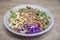 Vegan poke bowl with cashew nuts, red cabbage, dried onions, avocado and much more ingredients