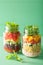 Vegan quinoa vegetable salad in mason jars