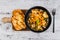 Vegan ravioli with vegetable broth peas and pumpkin and side of garlic bread