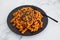 Vegan red pesto fusilli pasta with marinated tofu topping, healthy plant-based food