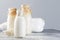 Vegan rice plant based milk in bottles, closeup, gray background. Non dairy alternative milk. Healthy vegetarian food and drink