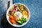 Vegan rice and vegetables salad, top view. Macrobiotic set with rice, hummus, avocado, broccoli and sweet potato