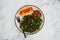 Vegan roasted pumpkin and kale salad with shredded teriyaki tofu and garlic bread, healthy plant-based food