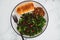 Vegan roasted pumpkin and kale salad with shredded teriyaki tofu and garlic bread, healthy plant-based food