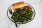 Vegan roasted pumpkin and kale salad with shredded teriyaki tofu and garlic bread, healthy plant-based food