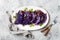 Vegan roasted red cabbage steaks on grey concrete background. Top view, flat lay.