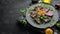 Vegan salad: beets, arugula and chickpeas on a black stone plate. Healthy diet food. Top view