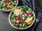 Vegan salad bowl with arugula, pear, pomegranate, cheese