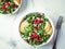 Vegan salad bowl with arugula, pear, pomegranate, cheese