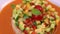 Vegan salad recipe based on bulgur with small vegetables, avocado, tomato, cucumber, pepper, nectarine fruit, tomato
