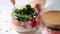 Vegan salad with vegetables and quinoa in glass jars, white background