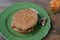 Vegan sandwich in hamburger bun on wooden table