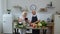 Vegan senior grandparents looking for a culinary recipe online on digital tablet, cooking salad