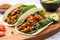 vegan soft shell taco with tempeh, lettuce, and tomato