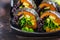 Vegan sushi rolls with black rice, avocado and sweet potato on black dish. Vegan food concept