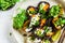 Vegan sushi rolls with black rice, avocado and sweet potato on white dish, top view. Vegan food concept