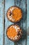 Vegan sweets. Homemade pumpkin tartlets with nuts, cocoa and coconut on shabby blue wooden boards