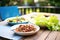 vegan tapenade spread on a lettuce wrap, sunny picnic table