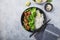 Vegan teryaki  tempeh or tempe buddha bowl  with rice, steamed broccoli, spinach  and lime on gray background. Healthy food