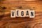 ` VEGAN ` text made of wooden cube on  wooden background