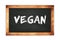 VEGAN text written on wooden frame school blackboard