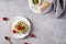 Vegan tiramisu with green matcha tea and raspberries on gray concrete background. Superfoods, healthy nutrition. Menu,