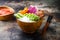 Vegan tofu poke bowls with seaweed, watermelon radish, cucumber, edamame beans and rice noodles. Copy space