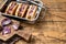 Vegan Vegetarian hot-dogs with onion and meatless sausage. Wooden background. Top view. Copy space