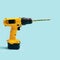 Vegan and vegetarian minimal concept. Yellow cordless drill with one fresh asparagus tip against a blue background
