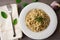 Vegan version of traditional italian pasta fettuccine alfredo with creamy white sauce garnished with basil