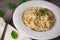 Vegan version of traditional italian pasta fettuccine alfredo with creamy white sauce garnished with basil