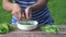 Vegan woman hands pod shell husk pease on wooden table. 4K