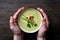 Vegaterian winter split pea turmeric soup on dark wooden background, close-up, top view