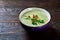 Vegaterian winter split pea turmeric soup on dark wooden background, close-up, top view