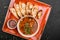 Vegetable bean soup with herbs in bowl with croutons on dark stone background. Healthy vegan food. Top view