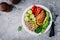 Vegetable bowl lunch with grilled chicken and quinoa, spinach, avocado, brussels sprouts, paprika and chickpea