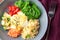 Vegetable buddha bowl lunch with salmon, feta cheese, couscous