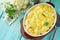 Vegetable casserole cauliflower meat and cheese on a wooden kitchen table, home kitchen