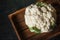 Vegetable cauliflower close-up. Texture of cauliflower on a wooden dark background. Place for your text