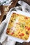 Vegetable clafoutis with red bell pepper and zucchini, grated parmesan cheese