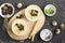 Vegetable cream soup puree with cheese, croutons, chives and toast grill in portion bowl on a dark background. Top view