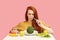 Vegetable diet. Sad dull woman holding broccoli on fork while making grimace