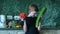 Vegetable diet theme. A positive Caucasian boy of 7-8 years old is holding a fresh huge tomato and vegetable marrow in the kitchen