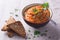 Vegetable dip from zucchini, tomatoes and parsley on a gray background