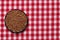 Vegetable food. Macro of a bowl of uncooked raw brown buckwheat grains on a red checkered tablecloth. Healthy eating. Top view